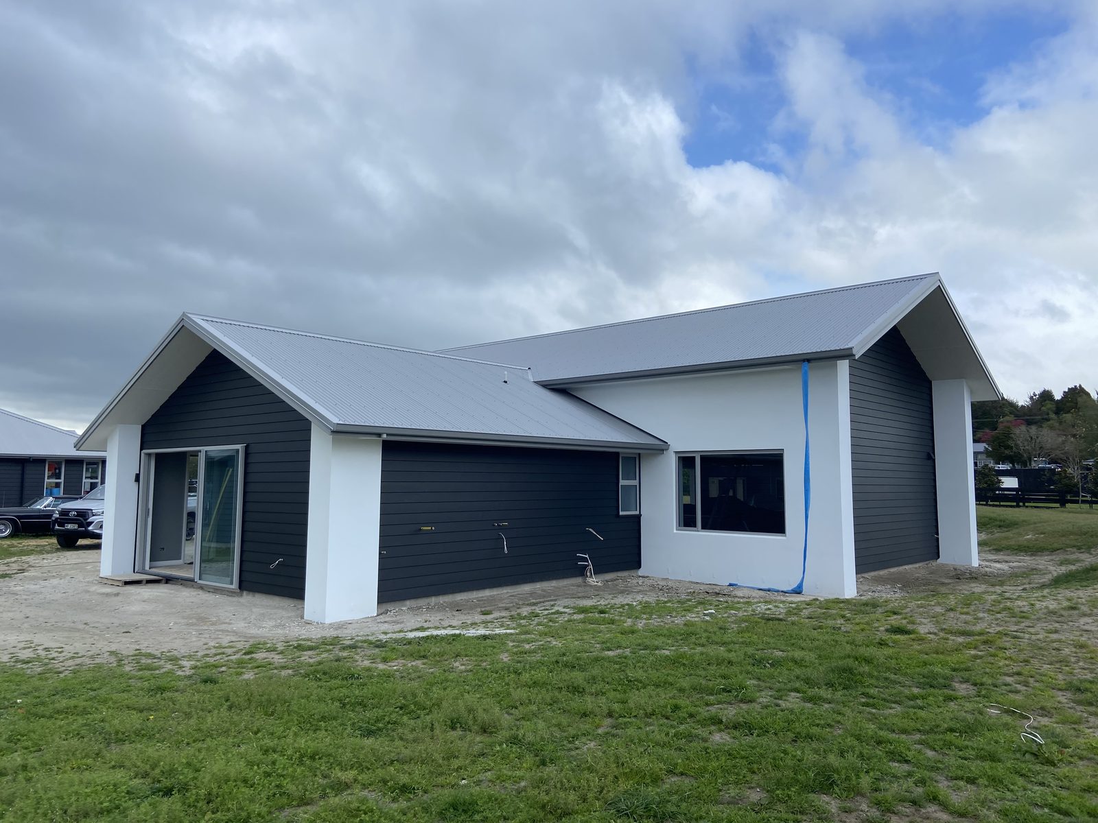 Finished charcoal exterior and white trim on a shed painting job in the Bay of Plenty